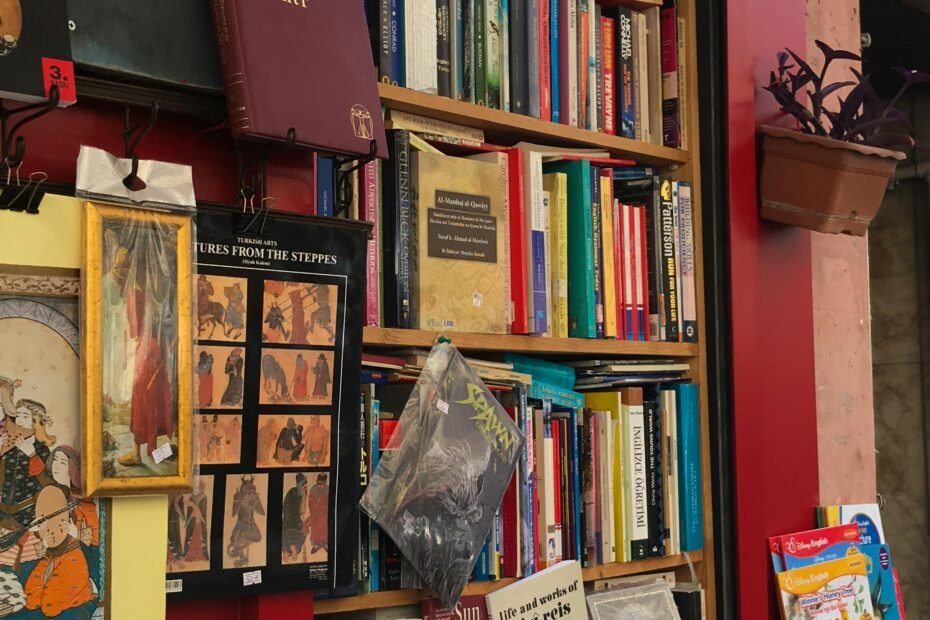 A vibrant display of books stacked outside a bookstore, showcasing a rich assortment of literature.