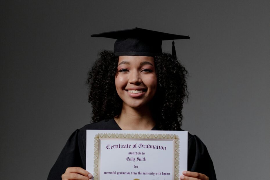 Happy young woman in graduation gown holding a certificate, celebrating success.